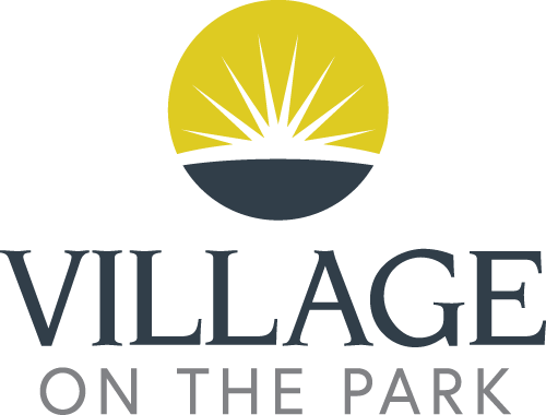 A logo with a sun and the words "Village on the Park".